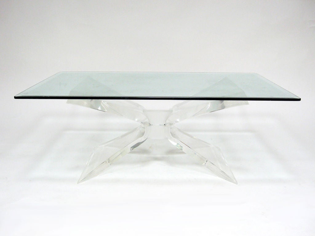 This dramatic coffee table by Lion in Frost is exquisitely crafted of clear and frosted lucite and supports a glass top with beveled edges.