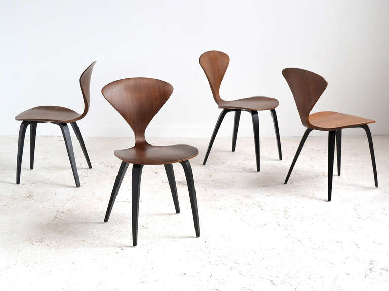 Lovely, light, and leggy, the Cherner chair was created in response to the perceived shortcomings of George Nelson's pretzel chair which was thought to be too fragile. 

Equally elegant, the Cherner chair has a seat and back made of varying
