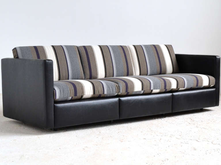 This handsome Pfister sofa has a body upholstered in black leather and loose cushions in Knoll 