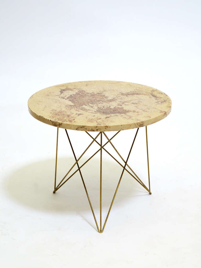 This rare side table by California designer Rene Brancusi references the Eames wire base tables of the same period, but offers a slightly more luxurious note. Rather than bare zinc wire rods for the base, the table has a brass colored finish. And