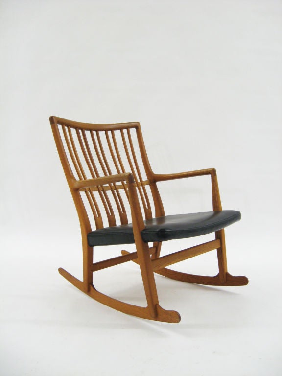 This fine rocking chair was Hans Wegner's first design and exhibits all the characteristics that would become Wegner's hallmarks. The refined, subtle design is executed with masterful craftsmanship. Some striking features are the pierced back rails,