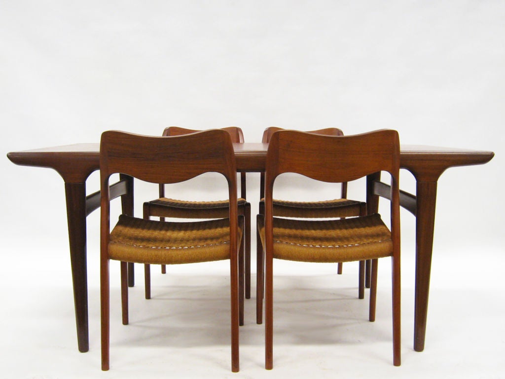 This beautiful dining table and chairs designed by Niels Moller and Johannes Andersen typify the Danish modern aesthetic. Expertly crafted, the sculptural details are not superfluous, but rather integral to the construction and function. The table