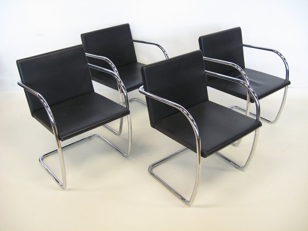 This set of 4 tubular Brno chairs are very handsome with the thin seat and back. Upholstered in black leather, they are in good original condition.