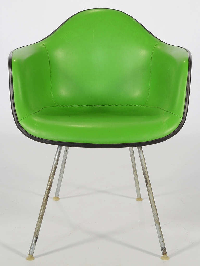 This model DAG-1 elephant hide gray fiberglass Eames armshell is upholstered in vivid kelly green Girard naugahyde. It is has the 