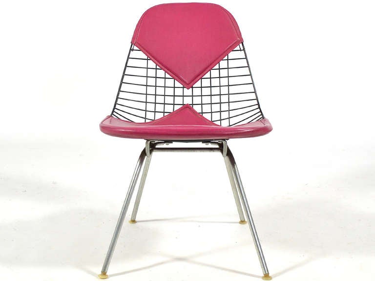 This terrific example of the Eames LKH-2 easy chair has a black wire seat, a bikini pad in magenta naugahyde designed by Alexander Girard and a zinc lounge height H base. Like California, where Charles and Ray lived and worked, it is cool, colorful,