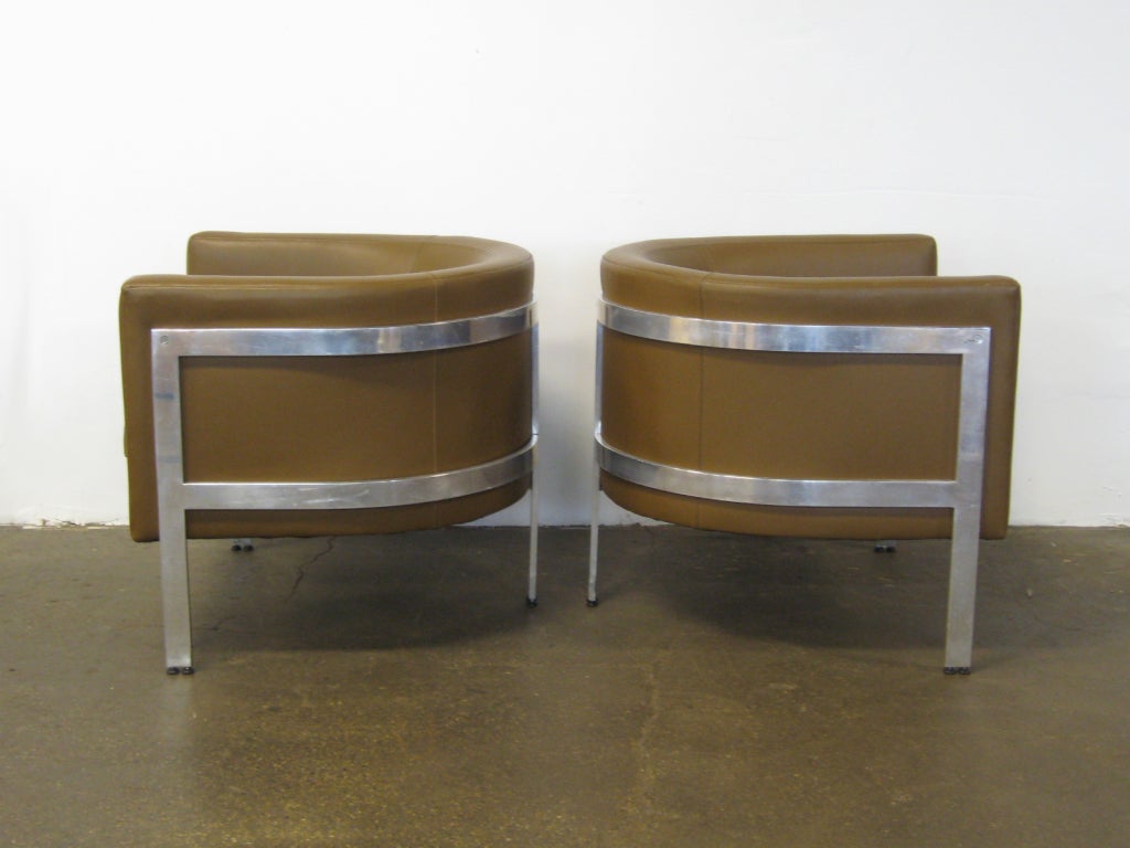 American Pair of three-legged barrel back lounge chairs by Erwin-Lambeth