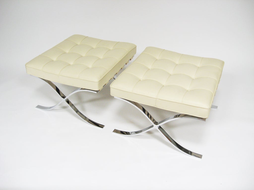 A pair of classic barcelona stools designed by Ludwig Mies van deer Rohe in 1929 and produced by Knoll. They are upholstered in buttery soft ivory leather.