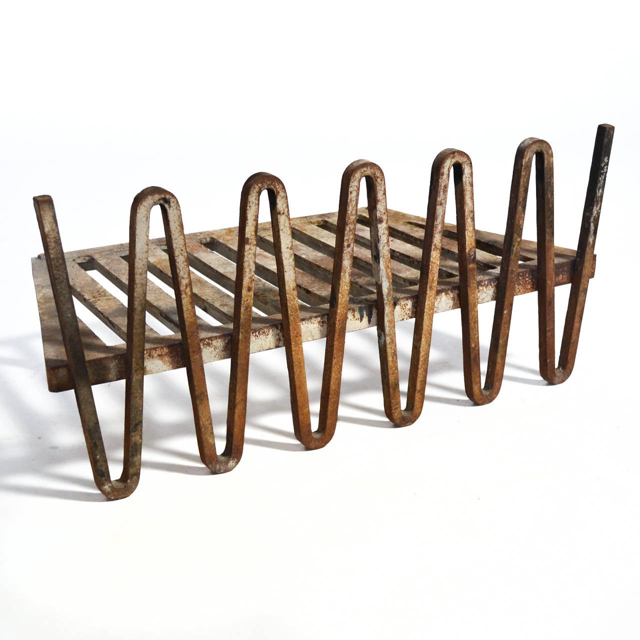 Designed by Mel Bogart for Stewart-Winthrop, this fire grate was selected for the 1955 Good Design exhibition. Created as part of a group of fireplace accessories, this rare design combines a grate or log holder with an undulating form which