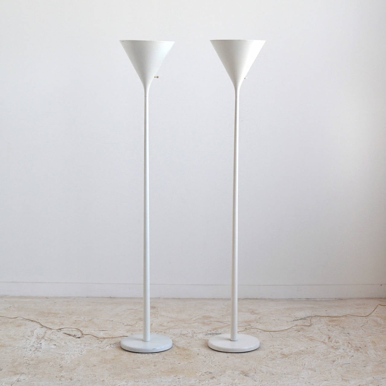A spare, elegant design, these torchiere lamps by Von Der Lancken & Lundqvist for Nessen have conical shades perched high on a slender rod attached to a circular weighted base. The reflected light they create in a room is some of the most flattering.