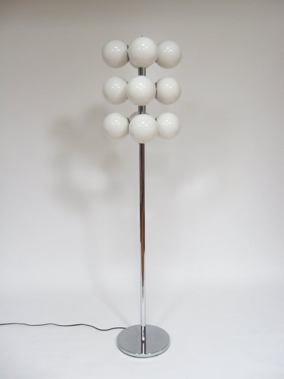Even more uncommon than the table or pendant version is the Lightolier floor lamp. This terrific design has qualities that cross categories, and can be described equally as pop-inspired and minimalist. Three rows of four globes surround the central