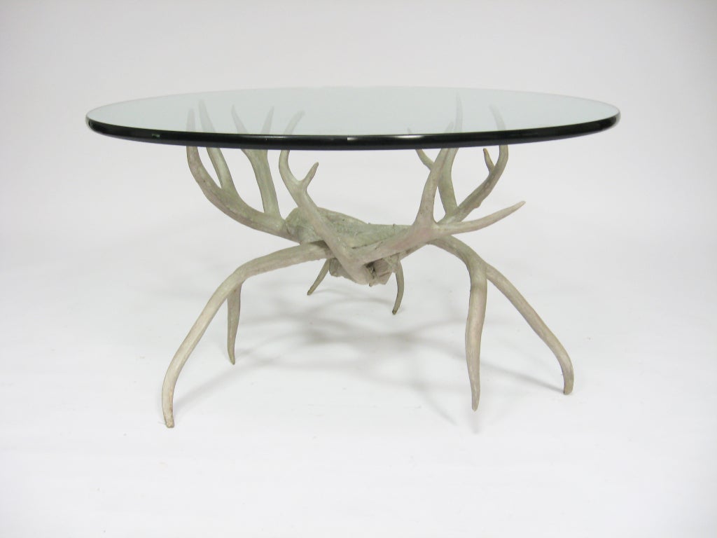This striking coffee table by Authur Court has a base of faux deer antlers cast in aluminum which supports a 36