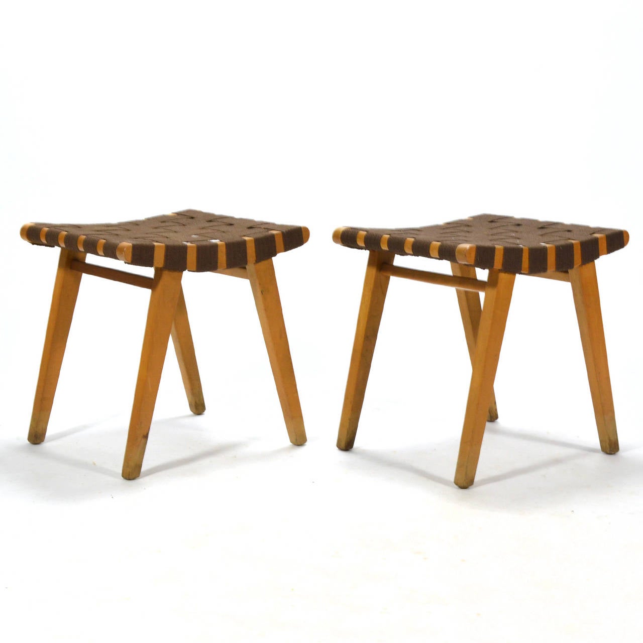In the 1940s, designers had to cope with material shortages due to the war effort. These stools were among Jens Risom's first designs for Knoll and employed woven webbing in lieu of an upholstered seat. The practical and elegant solution allows the