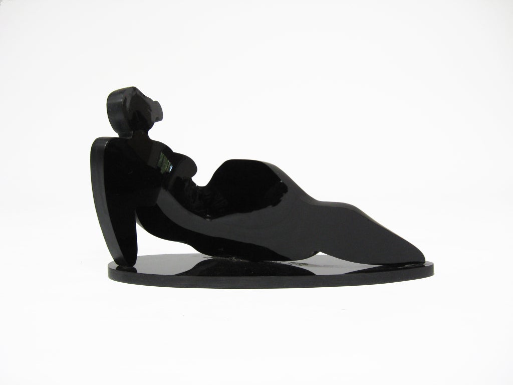 This sculpture by Rita Sargen-Simon in black lucite is a reclining odalisque made with a surprising economy of form. Two pieces (an undulating figure and an elliptical base) connect to create a delightful silhouette.