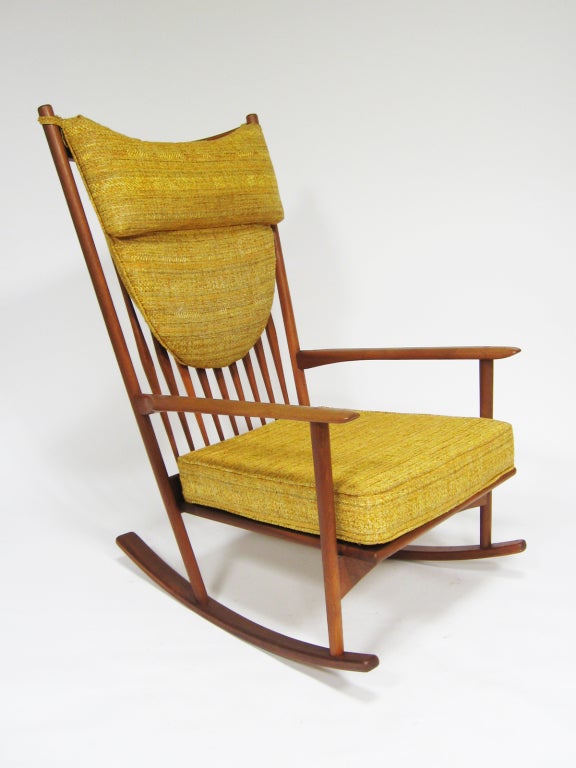 This rocking chair by Hans Olsen for Brdr Juul Kristensen has all the trademarks of Scandinavian design. Highly refined design with subtle details, exquisite construction that displays a mastery of wood working, and comfort that is integral to the