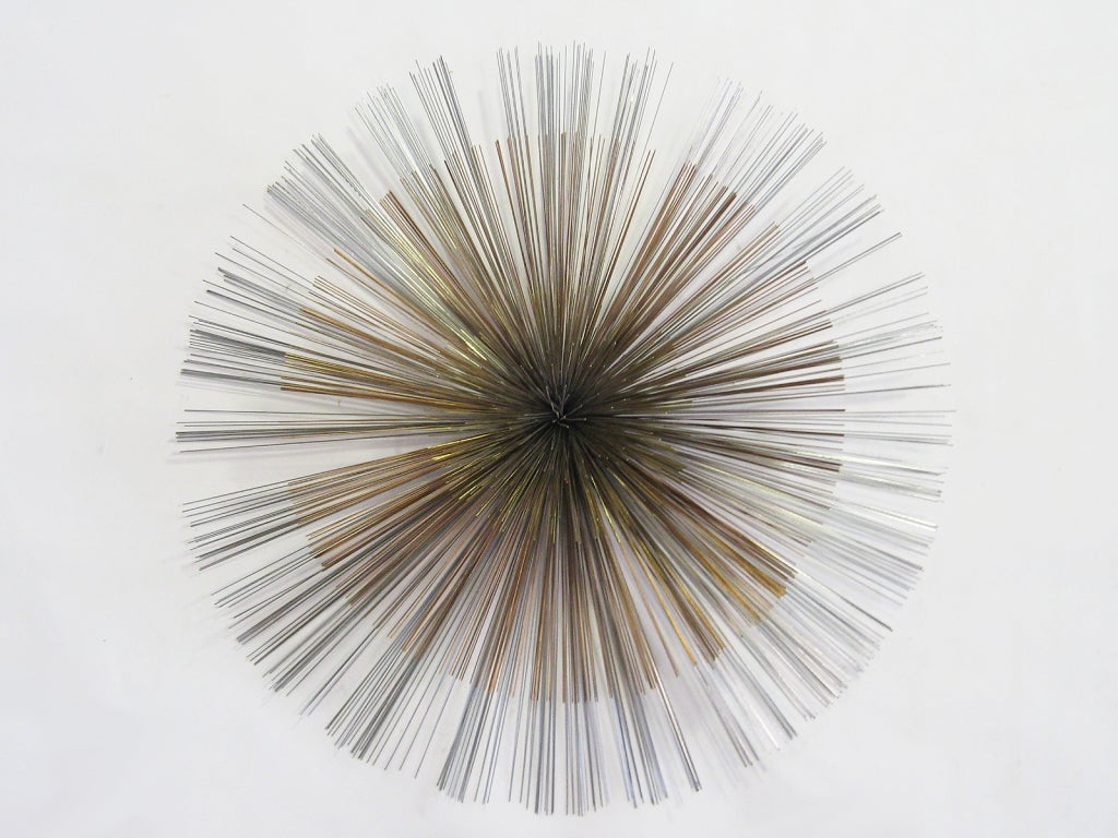 This large and dramatic Jere burst sculpture is clearly inspired by the work of Harry Bertoia. The Jere studio created a number of sculptures with this form, as either a single burst or a grouping of smaller bursts. This example is of note for its