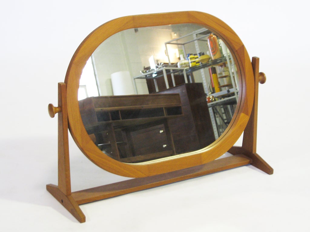 Like the best Scandinavian design, this vanity mirror marries graceful design with fine craftsmanship and a high degree of functionality. The oval framed mirror is supported by a base that references Shaker design and has two handles that tighten to