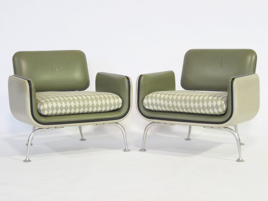 In production for only a single year, the furniture designed by Alexander Girard is scarce. This matched pair of model #66311 lounge chairs are excellent examples and include a very rare ottoman.  Initially conceived for Braniff Airlines, Herman