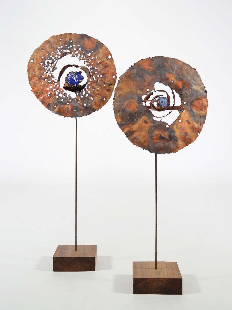 This delightful pair of sculptures in copper and enamel on wood bases are by Iowa artist James Bearden. 

Bearden's very tactile sensibility and playful forms shine in these companion pieces with their heavily worked copper surfaces, spiral lines