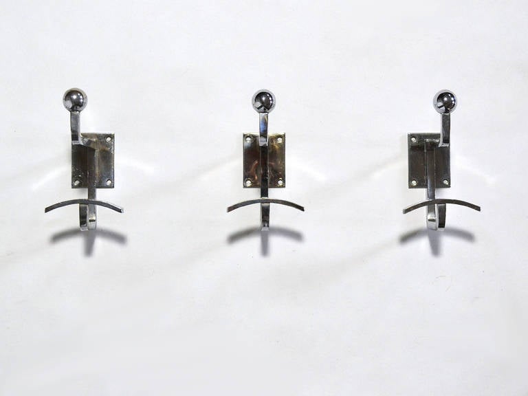 These three chrome plated Royère wall hooks can be used together or separately. They are beautiful by themselves on the wall, but can hold nearly anything: coats, hats, clothes, umbrellas, bags...

Each piece is signed on the back with an