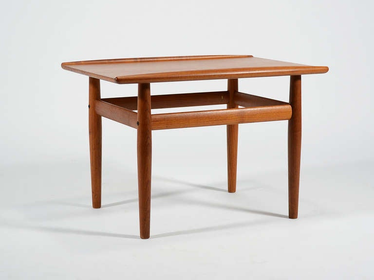 This Classic Danish design by Greta Jalk has several fine details including solid edges with raised lips on two sides and slender tapered legs.

      