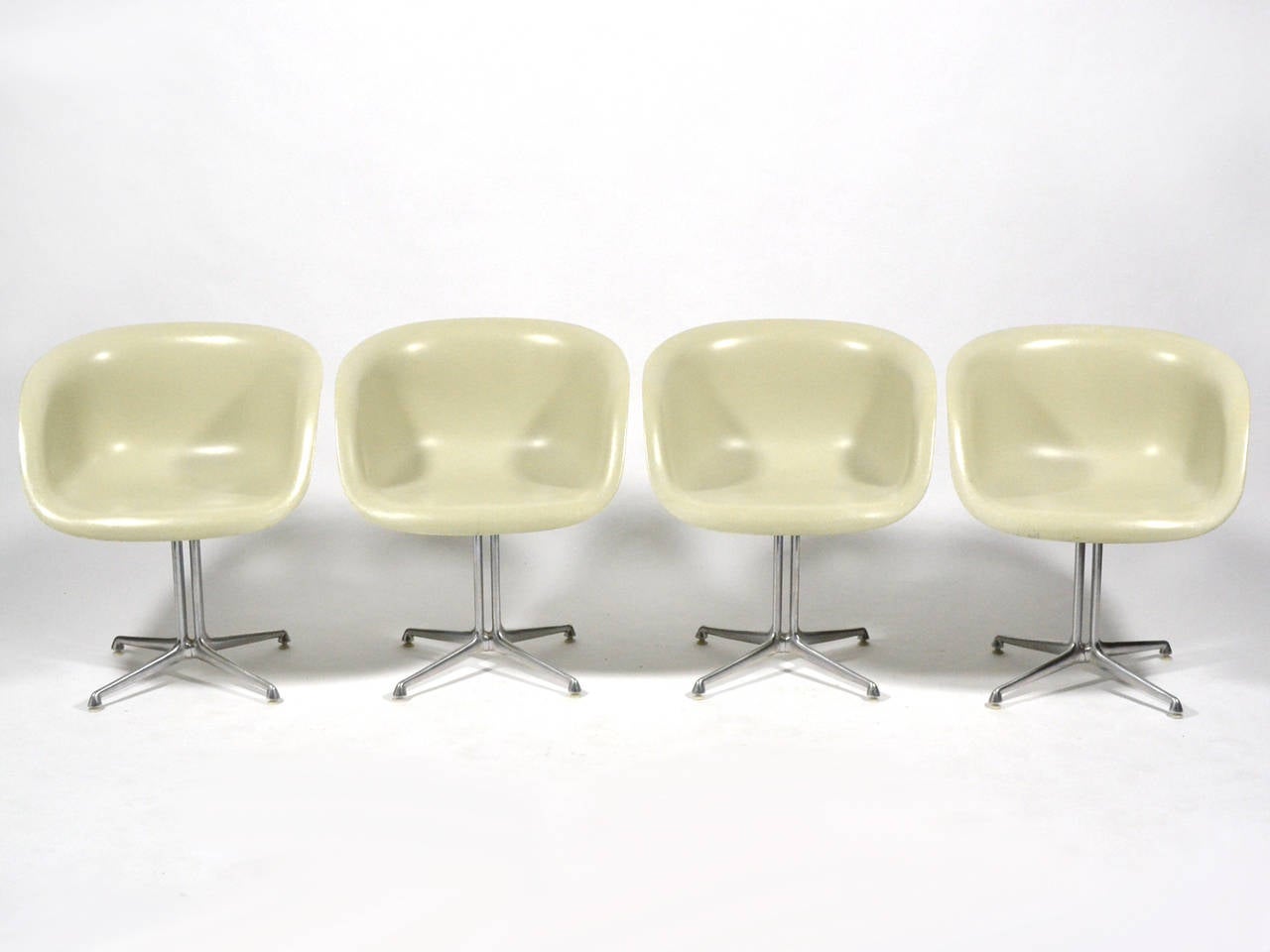 Created in collaboration with Charles and Ray Eames, when Alexander Girard was designing the interior of La Fonda Del Sol restaurant, these chairs are a variation of the Eames fiberglass shell chair with a lower back and a specially designed four