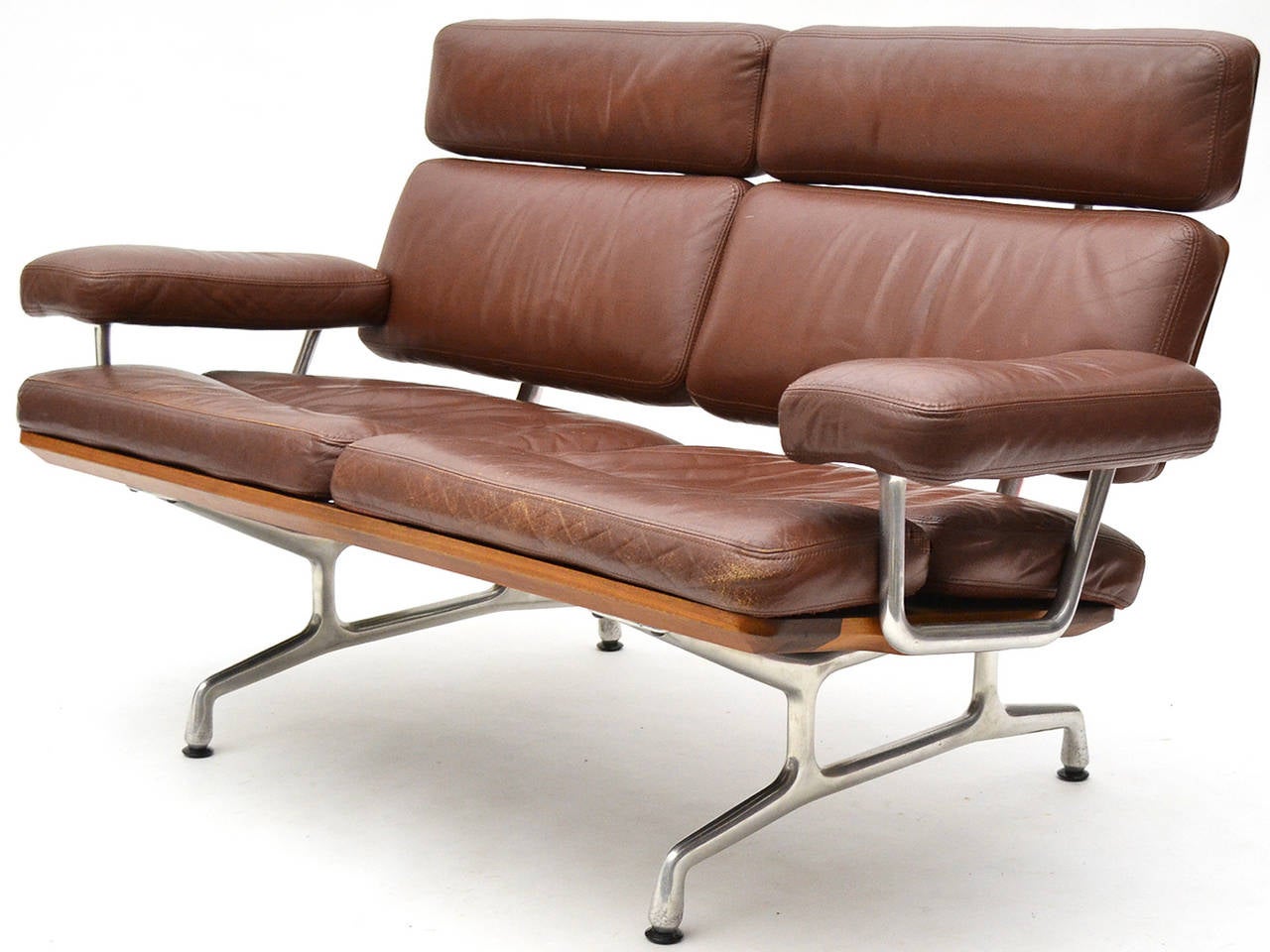 The teak sofa by Charles and Ray Eames was the last design the husband and wife team created. Originally conceived in the 1970s, the sofa shares characteristics with several other Eames designs including the sofa compact, the later model 3473 sofa,