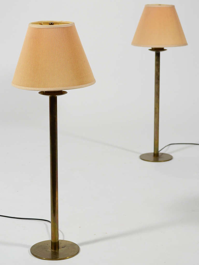 These elegant and understated table lamps in brass by Hans-Agne Jakobsson are perfect for the nightstand or on a credenza. The Minimalist form is complimented by impeccable construction. The brass has a rich patina from age.

Marked with label on