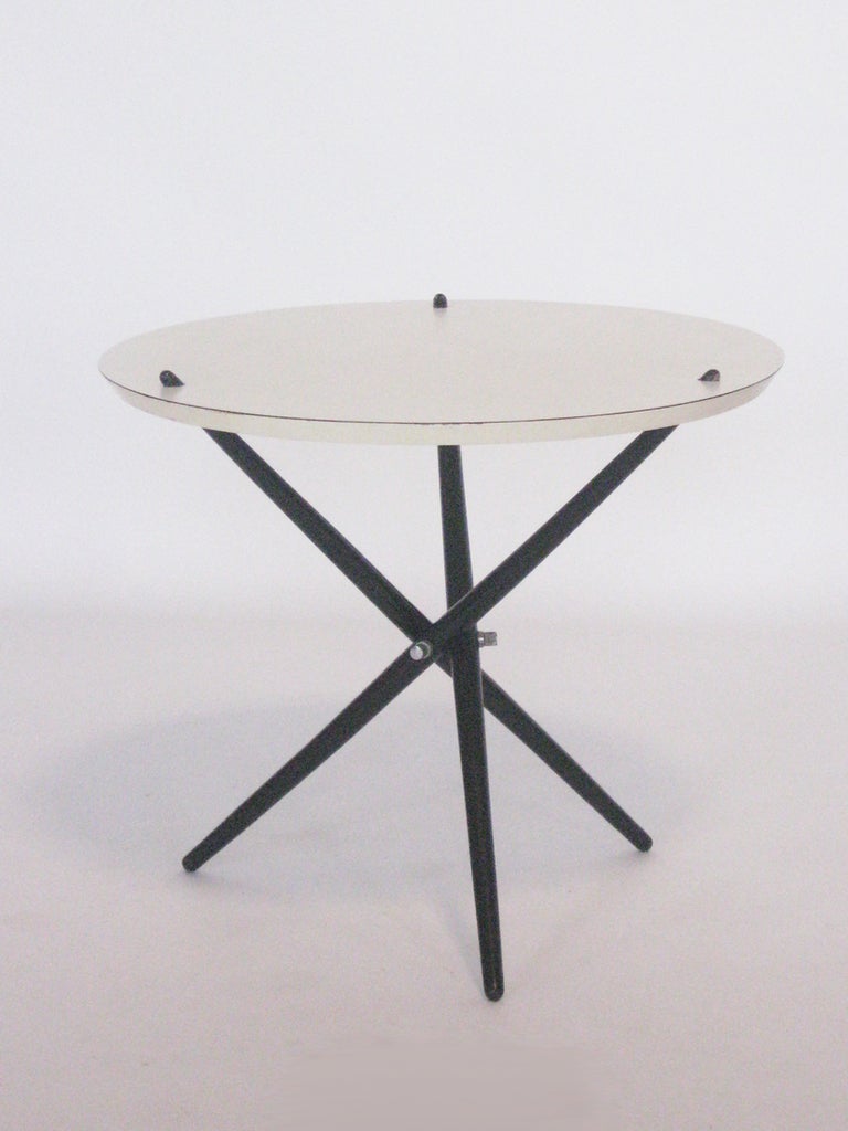 A great Hans Bellmann design from 1947 and produced by Knoll, the model 103 tripod table is attractive and versatile. The top is demountable from the folding ebony legs and folds flat for easy shipping and storage when not in use. 

The scale