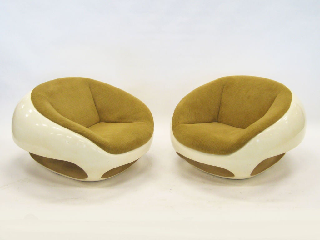 This uncommon pair of lounge chairs by Mario Sabot are not just visually arresting, they are also quite comfortable. The sculptural base of fiberglass is made more interesting with the open voids, and the upholstered seats offer support with a nice