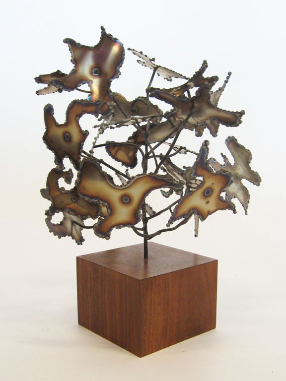 This compelling sculpture in brazed brass sits on a walnut base. Reminiscent of Bertoi'a bush forms, the piece has a very dynamic composition. Signed and dated on one of the “leaf” elements, it is in excellent original condition.
