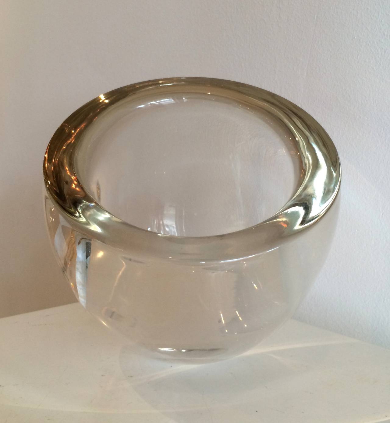 Clear Murano bowl sits off-center, signed 