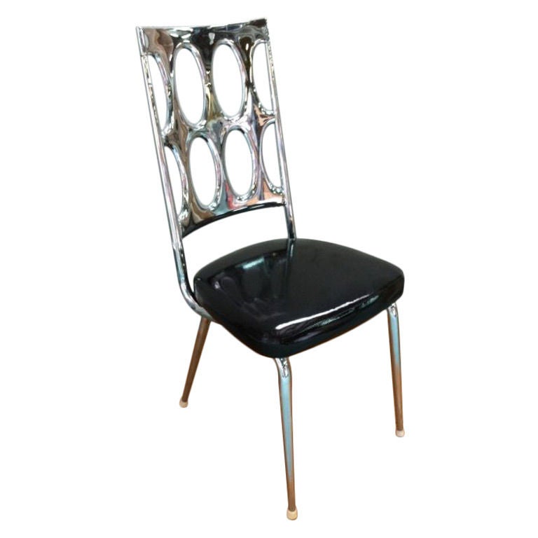 Very unusual chrome-backed dining side chairs, newly plated and upholstered.  Set of four.