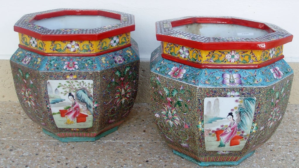 Wonderful pair of famille rose Chinese export multi-color octagonal fishbowls, four sides with figural and landscape panel designs surrounded by a profusion of tightly designed floral and fauna with larger floral design on top.
