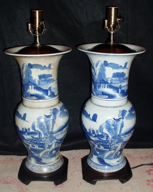 Handsome Pair of Blue & White Chinese Porcelain Trumpet Vases Mounted as Lamps, with Unique Landscape & Architectural Designed Surfaces, and Mounted on Dark Brown Carved Wood Bases