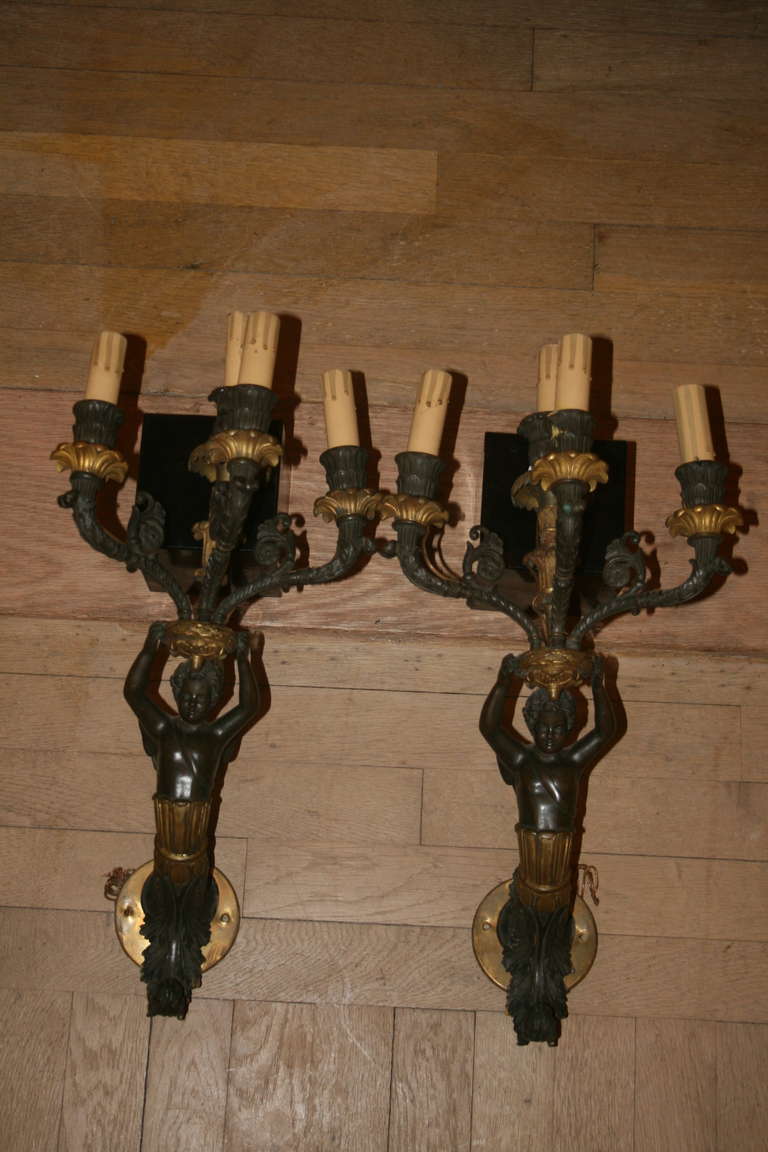 Pair of Charles X Style bronze doré and patinated four arm candelabra now as wall lights with classically designed ornamental details throughout, 19th century. 