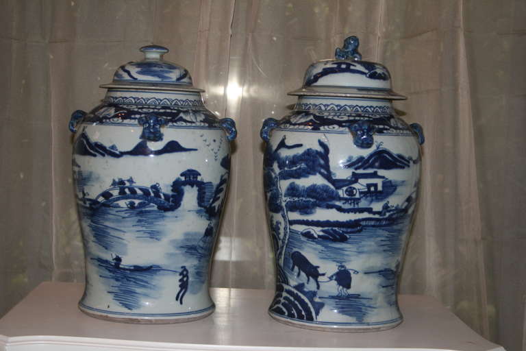 Matched pair of blue and white Chinese export lidded jars with mountainous scenery, foo dogs and birds. 
ACC-69461.