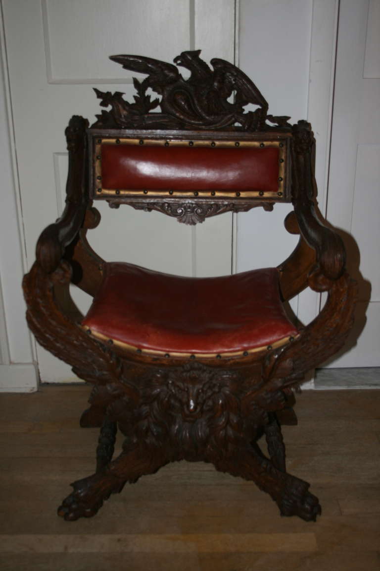 Incredibly regal 18th century hand-carved oak fauteuil surmounted with an eagle, quiver and arrows above the backrest and flanked by dragon heads, with an open winged Lion of Judah beneath the front of the seat.