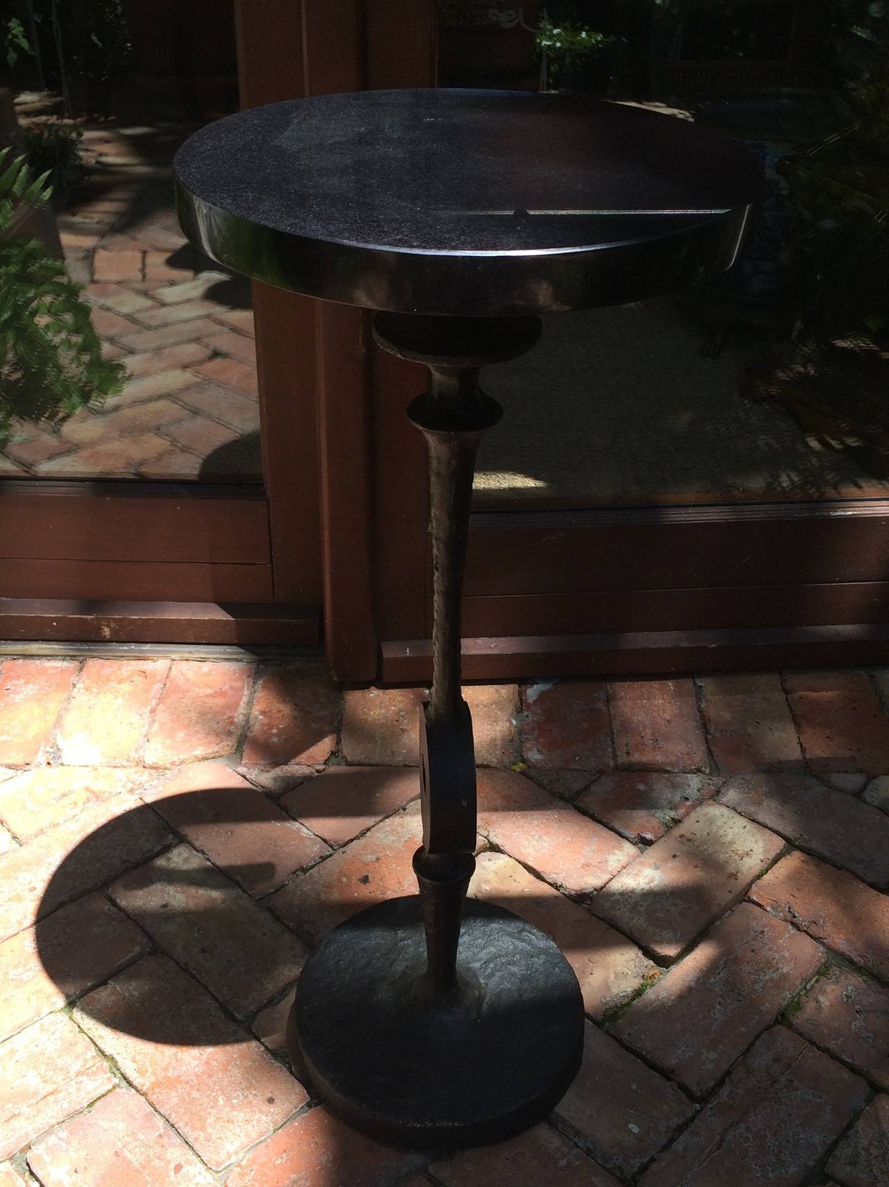 Modern Art Nouveau style side or drinks table, black hammered like metal base with dark marble top.