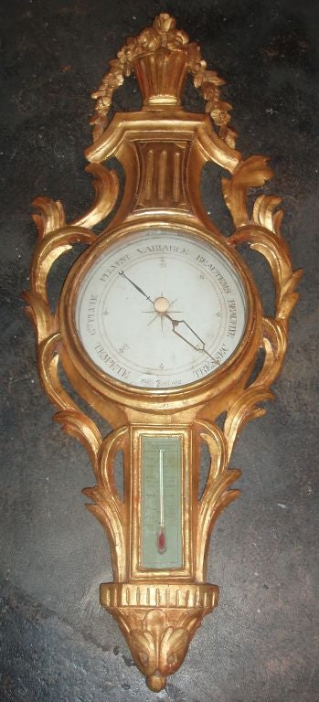 Very charming carved and gilded acanthus leaf framed Louis XVI period wall barometer with glass covered central dial and glass thermostat beneath; both with original hand written terminology indicating climate changes and conditions, with cascading