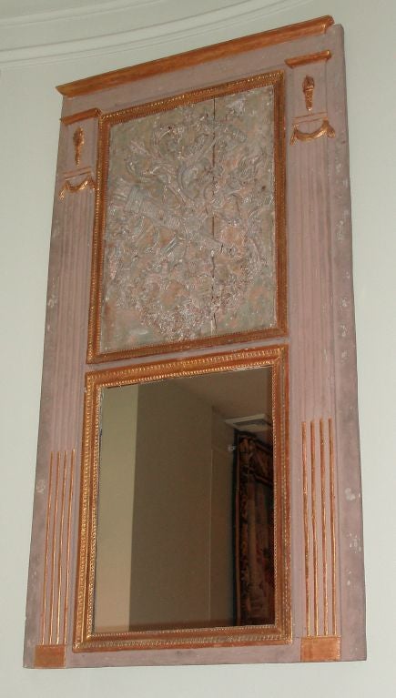 Large Louis XVI period pale gray painted and parcel-gilt finished trumeau with upper central carved wood panel; 