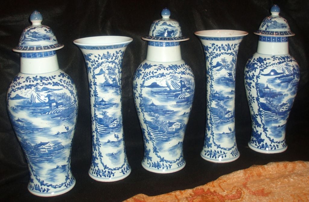 Beautiful garniture of blue and white Chinese porcelain, consisting of three covered jars and two vases.
Each decorated with mountainous landscapes and river scenes within floral framing and larger blue floral designs.