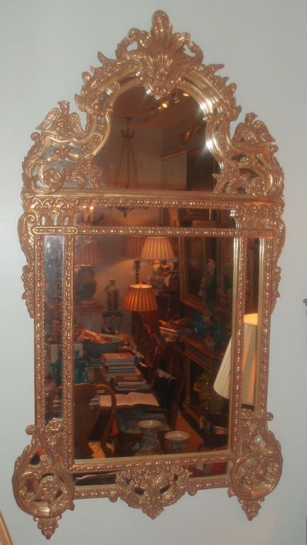 Giltwood Regence-style mirror, finely detailed  with the top quarter flanked by phoenix birds and with acanthus leaf design throughout. Very decorative.