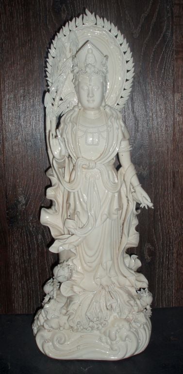 Etheral Blanc de Chine Porcelain Figure of Quan Yin, The Chinese Goddess of Mercy, Compassion, and Protection; Standing on Crested Waves Water and Dressed in Flowing Robes