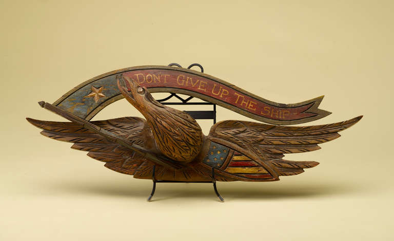This is a wonderful piece of American folk - hand-carved, wooden late 19th/ early 20th century American eagle in the John Bellamy style.  The piece features the banner 