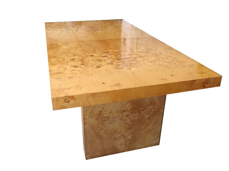 The dining table has a pleasing patchwork burl wood grain. Two 18