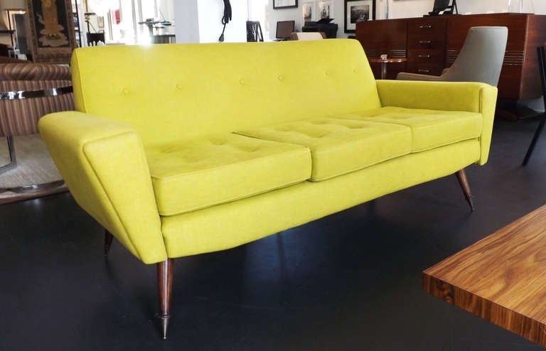 Beautiful 1950's sofa with remarkable legs. Legs are Mahogany with a brass ball tip.  