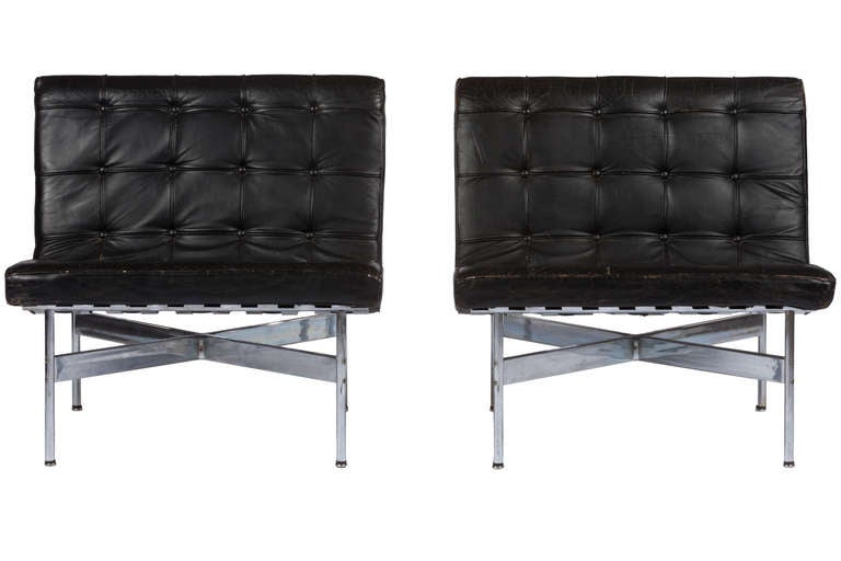 Pair of black leather Laverne lounge chairs designed William Katavalos, Ross Littell and Douglas Kelly, circa 1952. Some loss to chrome and minor hardness to cushions.