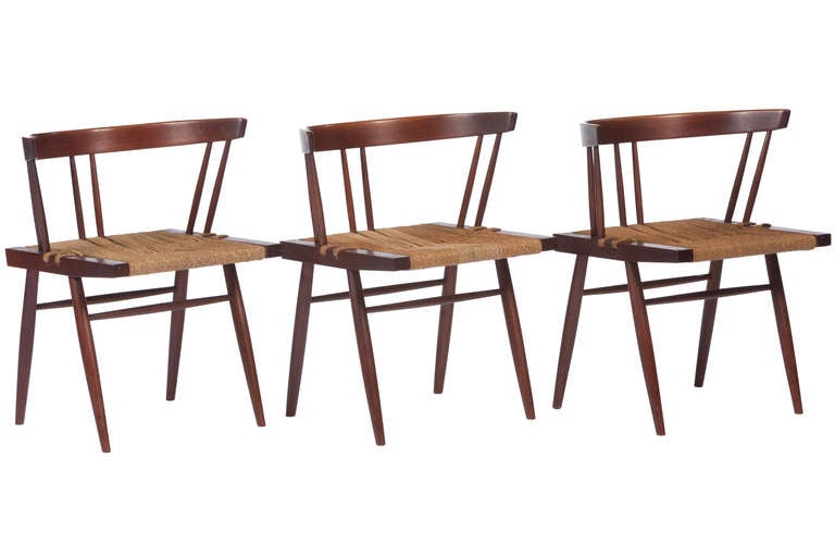 Set of 10 George Nakashima Grass seated dining chairs in American black walnut with sea-grass seats. Chairs come with provenance. Some variation in color of seats to a few chairs.