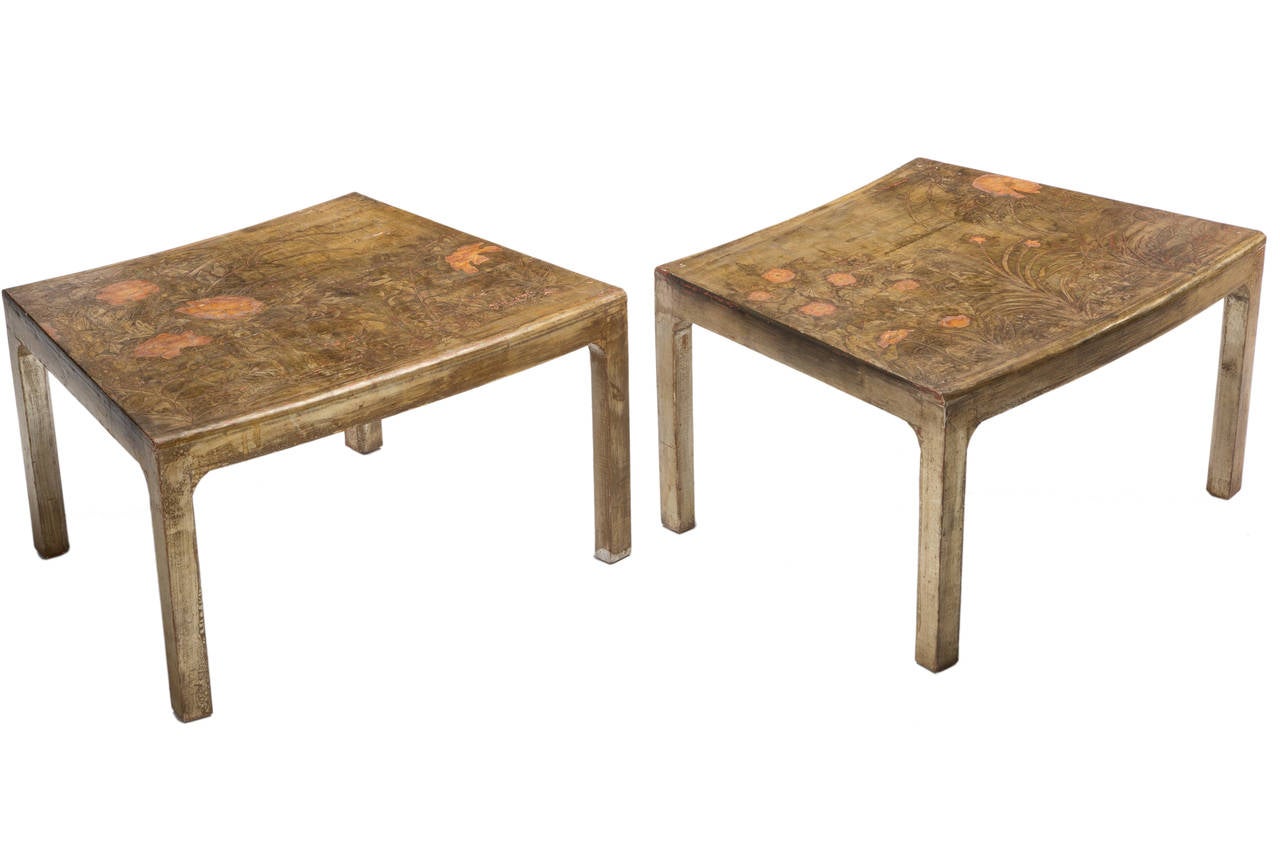 Elegant pair of trapezoid shaped side tables designed and made by artist Max Kuehne. Beautifully decorated surface with a rubbed gilt finish and incised floral decoration.