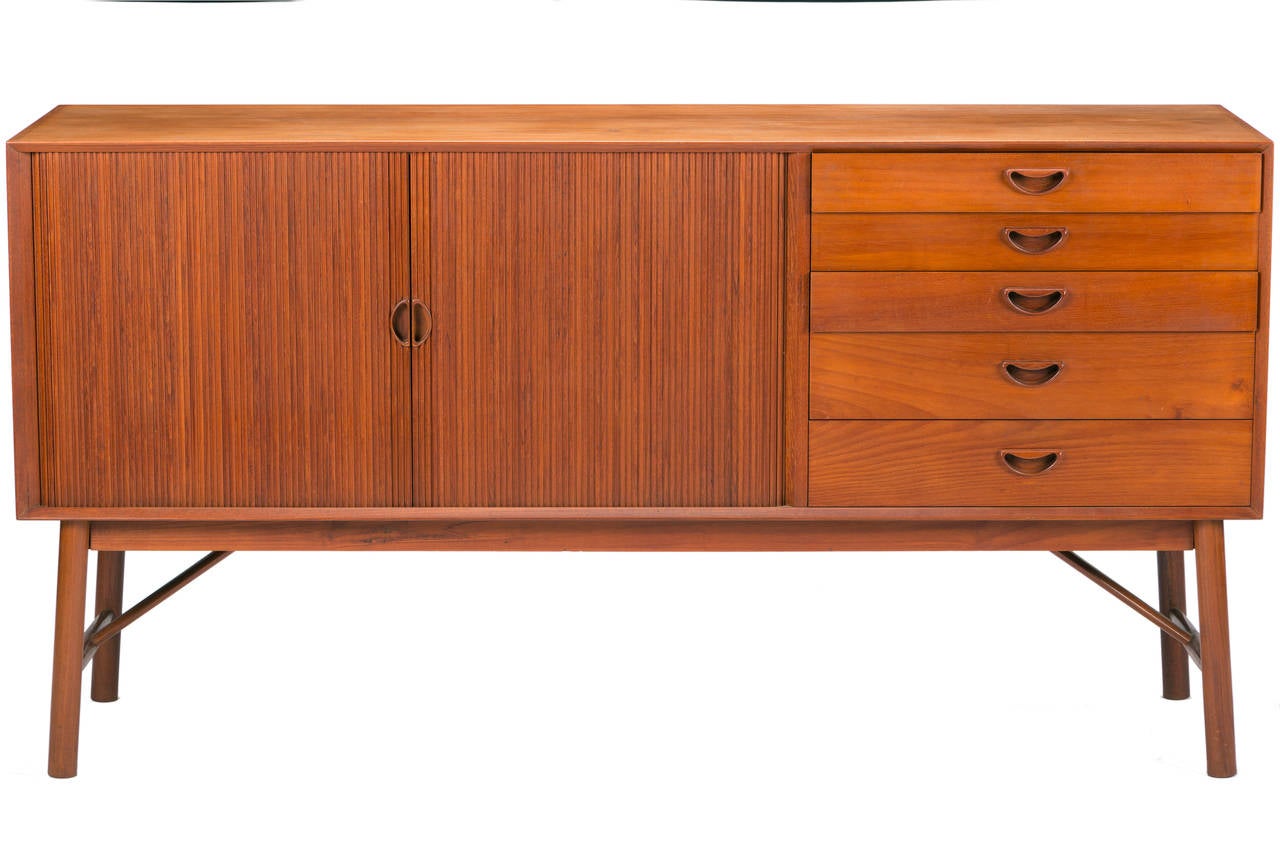 Solid teak sideboard by Peter Hvidt & Olga Mølgaard Nielsen. Produced by Soborg Furniture Denmark, cabinet features five drawers, two tamboured doors and solid wood construction with finger joints on top and bottom of cabinet.